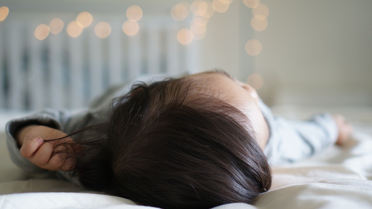 Лишение на 6 месяцев. Двухлетний спящий ребенок девочка с черными волосами.